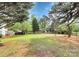 Spacious backyard with lush lawn, patio and wood deck offers serene outdoor living at 2217 Heath Lake Dr, Mint Hill, NC 28227