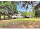 Expansive backyard featuring a patio, mature trees, and a lush lawn at 2217 Heath Lake Dr, Mint Hill, NC 28227