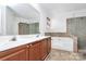 Primary bathroom with double sink vanity, soaking tub, and glass enclosed shower at 2217 Heath Lake Dr, Mint Hill, NC 28227