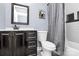 Bathroom with dark wood cabinets, gray walls, and tiled shower and tub surround at 2217 Heath Lake Dr, Mint Hill, NC 28227