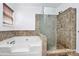 Bathroom featuring a soaking tub and glass-enclosed shower with tiled surround at 2217 Heath Lake Dr, Mint Hill, NC 28227