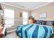 Cozy bedroom with natural light, complemented by a wooden dresser and blue striped comforter at 2217 Heath Lake Dr, Mint Hill, NC 28227