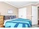 Bedroom with neutral walls, features a queen size bed, and convenient closet with multiple doors at 2217 Heath Lake Dr, Mint Hill, NC 28227