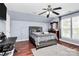 Bedroom with vaulted ceilings, gray walls, ceiling fan, and laminate wood flooring at 2217 Heath Lake Dr, Mint Hill, NC 28227