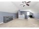 Bonus room with ceiling fan includes neutral carpet and blue accent wall at 2217 Heath Lake Dr, Mint Hill, NC 28227