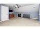 Bonus room with ceiling fan features neutral carpet, blue accent wall and furnishings at 2217 Heath Lake Dr, Mint Hill, NC 28227