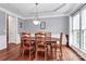 Bright dining room with hardwood floors, a tray ceiling, and a classic light fixture at 2217 Heath Lake Dr, Mint Hill, NC 28227