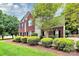 Well-manicured lawn and mature landscaping surround this charming red brick home at 2217 Heath Lake Dr, Mint Hill, NC 28227