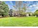 Beautiful home featuring a large front lawn and mature shade trees at 2217 Heath Lake Dr, Mint Hill, NC 28227
