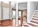Foyer with wood floors, white columns, and staircase at 2217 Heath Lake Dr, Mint Hill, NC 28227