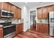 Well-equipped kitchen featuring wood floors, stainless steel appliances, and ample cabinet space at 2217 Heath Lake Dr, Mint Hill, NC 28227