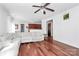 Open-concept living room with wood floors and view of kitchen and dining area at 2217 Heath Lake Dr, Mint Hill, NC 28227