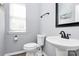 Powder room with sink, toilet, and decor at 2217 Heath Lake Dr, Mint Hill, NC 28227