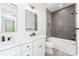 Bathroom with dual sinks, modern fixtures, marble countertop, soaking tub, and a gray-tiled shower at 2965 Beech Nut Rd, Charlotte, NC 28208