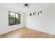 Bright, empty bedroom featuring hardwood flooring, a large window and recessed lighting at 2965 Beech Nut Rd, Charlotte, NC 28208