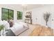 Well-lit bedroom features hardwood floors, large windows, and stylish decor with a neutral color palette at 2965 Beech Nut Rd, Charlotte, NC 28208