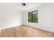 Bedroom with hardwood floors, large window, and white walls offers a serene living space at 2965 Beech Nut Rd, Charlotte, NC 28208