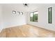 A bright empty bedroom with hardwood flooring, a large window, and recessed lighting at 2965 Beech Nut Rd, Charlotte, NC 28208