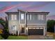 Beautiful two-story home with a gray exterior, stone accents, and an attached two-car garage at 2965 Beech Nut Rd, Charlotte, NC 28208