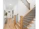 Hallway and staircase with wood treads and black metal railings leading up to the second floor at 2965 Beech Nut Rd, Charlotte, NC 28208