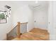 Hallway with hardwood floors features an elegant chandelier, staircase, and white walls at 2965 Beech Nut Rd, Charlotte, NC 28208