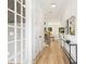 Hallway with wood floors, white walls, and decorative mirror at 2965 Beech Nut Rd, Charlotte, NC 28208