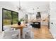 Beautiful white kitchen with a center island, stainless steel appliances, modern lighting, and a dining area at 2965 Beech Nut Rd, Charlotte, NC 28208