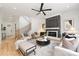 Comfortable living room with a fireplace, ceiling fan, and light wood floors at 2965 Beech Nut Rd, Charlotte, NC 28208
