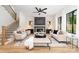 Inviting living room with fireplace, comfortable seating, hardwood floors and a ceiling fan at 2965 Beech Nut Rd, Charlotte, NC 28208