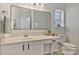 Bright bathroom featuring a framed mirror, white vanity, and a window for natural light at 3099 Windsor Trace Dr, Fort Mill, SC 29707