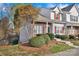 Charming townhouse featuring brick and vinyl siding, neat landscaping, mulched beds, and steps to front door at 3099 Windsor Trace Dr, Fort Mill, SC 29707
