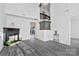 Open-concept living area with modern flooring, fireplace, and staircase at 3099 Windsor Trace Dr, Fort Mill, SC 29707