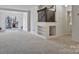 Spacious carpeted living room with a staircase, open floorplan, and access to the backyard at 3099 Windsor Trace Dr, Fort Mill, SC 29707