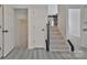 Carpeted staircase with dark wood railing leads to the next level of this bright home at 3099 Windsor Trace Dr, Fort Mill, SC 29707