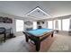 Bright and airy game room with a billiard table, ample seating, and stylish decor, perfect for entertaining at 3841 Shasta Cir, Clover, SC 29710