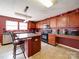 Spacious kitchen with tile floors, wood cabinets, stainless steel appliances, and eat at island at 3841 Shasta Cir, Clover, SC 29710