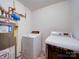 Bright laundry room features washing machine, dryer, and storage in a dedicated space at 3841 Shasta Cir, Clover, SC 29710