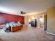 Carpeted main bedroom featuring a ceiling fan, access to the ensuite bathroom, and a neutral color scheme at 3841 Shasta Cir, Clover, SC 29710