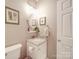 Cozy bathroom with a granite vanity top, round mirror and a combination tub and shower at 4032 River Falls Dr, Lowell, NC 28098