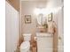 Cozy bathroom with a granite vanity top, round mirror and a combination tub and shower at 4032 River Falls Dr, Lowell, NC 28098