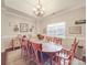 Large dining room featuring a long wooden table with seating for ten and a bright window at 4032 River Falls Dr, Lowell, NC 28098