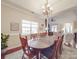 Spacious dining room with an oval wooden table set for eight people near the living room at 4032 River Falls Dr, Lowell, NC 28098
