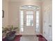 Inviting foyer with a beautifully paneled front door, natural light, and hardwood flooring at 4032 River Falls Dr, Lowell, NC 28098
