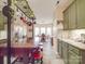 Green cabinets and stainless appliances surround a dark wood kitchen island with seating at 4032 River Falls Dr, Lowell, NC 28098