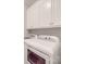 Convenient laundry area with white cabinetry and modern washer and dryer units at 4032 River Falls Dr, Lowell, NC 28098