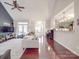 Bright living room boasts hardwood floors, neutral paint, vaulted ceilings, and tons of natural light at 4032 River Falls Dr, Lowell, NC 28098