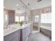 A luxurious main bathroom featuring a double vanity, glass shower, and soaking tub at 4032 River Falls Dr, Lowell, NC 28098