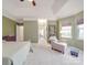 Spacious main bedroom featuring a tray ceiling, sitting area, and neutral decor at 4032 River Falls Dr, Lowell, NC 28098