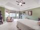 Green-walled main bedroom with a sitting area and tray ceiling at 4032 River Falls Dr, Lowell, NC 28098