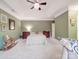 Bright main bedroom with a tray ceiling, neutral walls, and plush carpet at 4032 River Falls Dr, Lowell, NC 28098